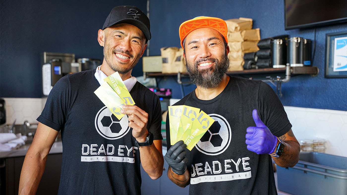 Dead Eye Coffee Bar employees pose with GenenMoney to celebrate their participation in Genentech Goes to Town.